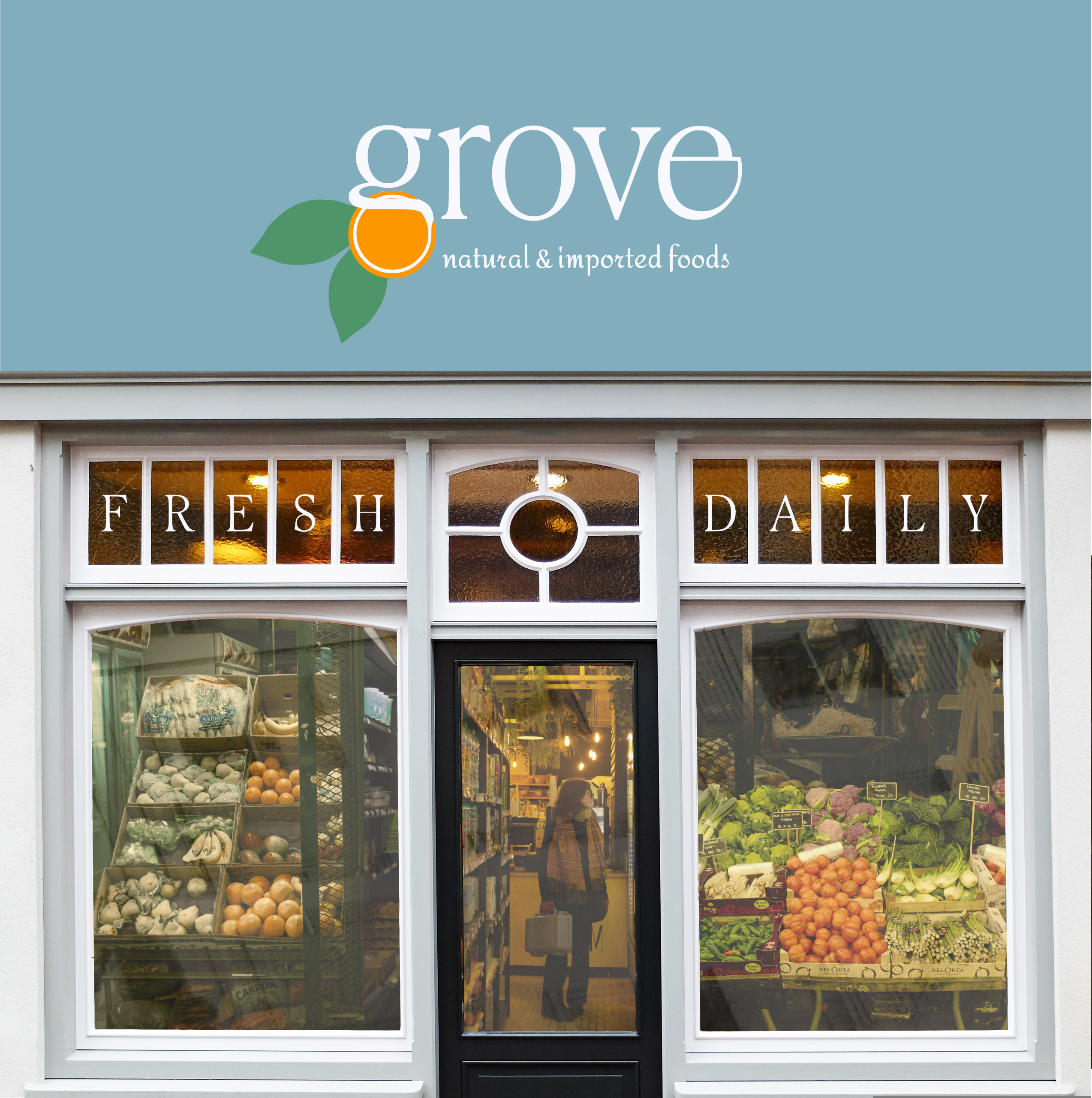 A photograph of a small grocery market with views of the shop interior through the windows and a sign above which reads 'grove natural and imported foods'.